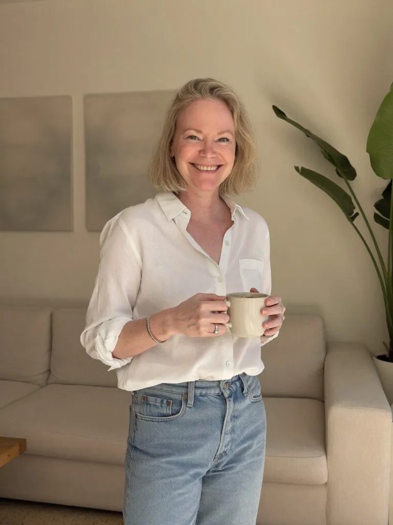 AI personal brand portrait with coffee mug in a minimalist living room