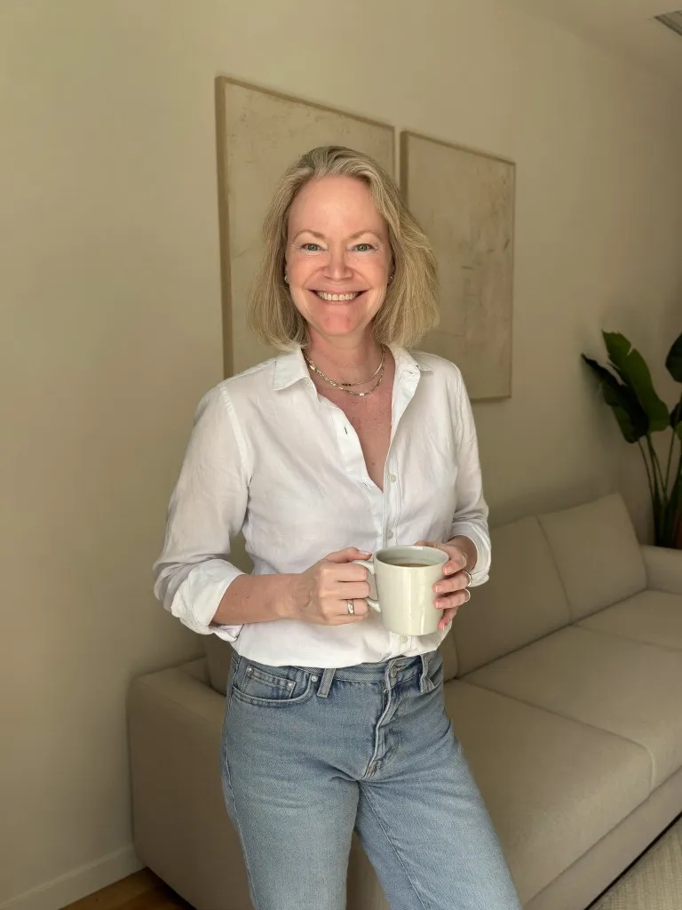 AI personal brand portrait in a minimalist living room with coffee mug